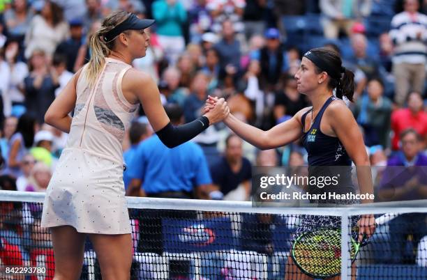 Anastasija Sevastova of Latvia shakes hands with Maria Sharapova of Russia after defeating her in their women's singles fourth round match on Day...