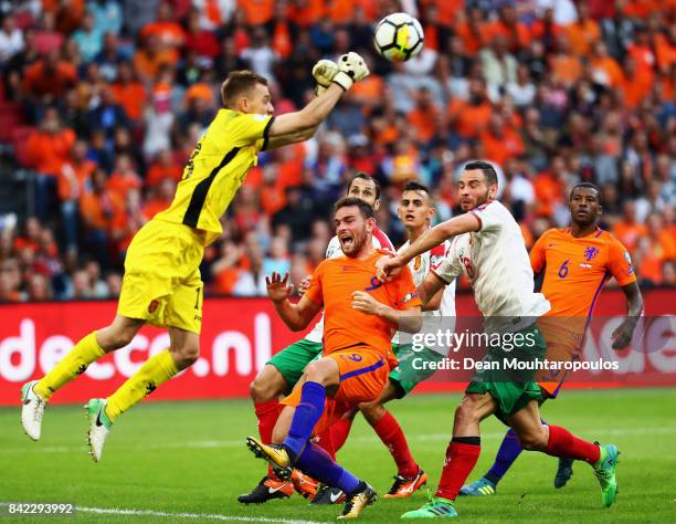 Goalkeeper, Plamen Iliev of Bulgaria punches the ball away from Georginio Wijnaldum and Vincent Janssen of the Netherlands during the FIFA 2018 World...