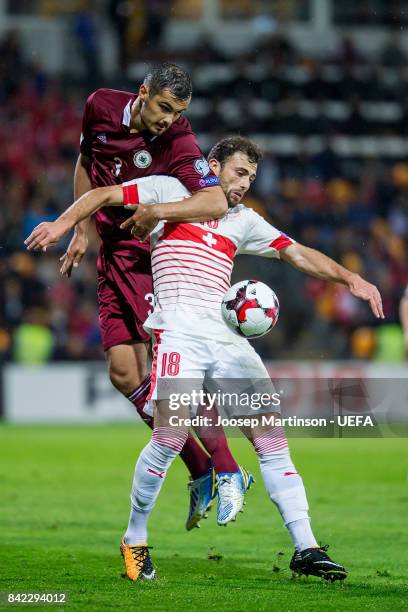 Nikita Kolesovs of Latvia competes with Admir Mehmedi of Switzerland during the FIFA 2018 World Cup Qualifier between Latvia and Switzerland at...