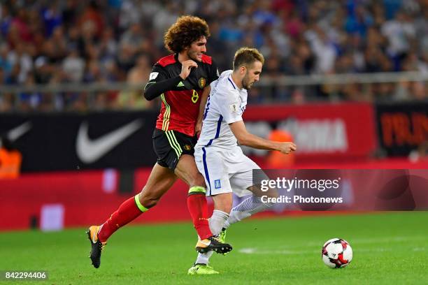 Marouane Fellaini midfielder of Belgium is fighting for the ball with Kostas Fortounis forward of Greece during the World Cup Qualifier Group H match...