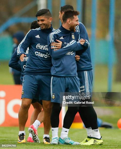 Lionel Messi, Ever Banega and Angel Di Maria smile during a training session at 'Julio Humberto Grondona' training camp on September 03, 2017 in...