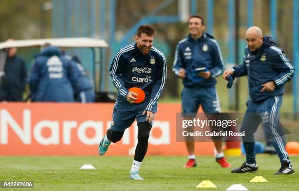 Jorge Sampaoli, coach of Argentina gives directions to Lionel Messi during a training session at 'Julio Humberto Grondona' training camp on September...