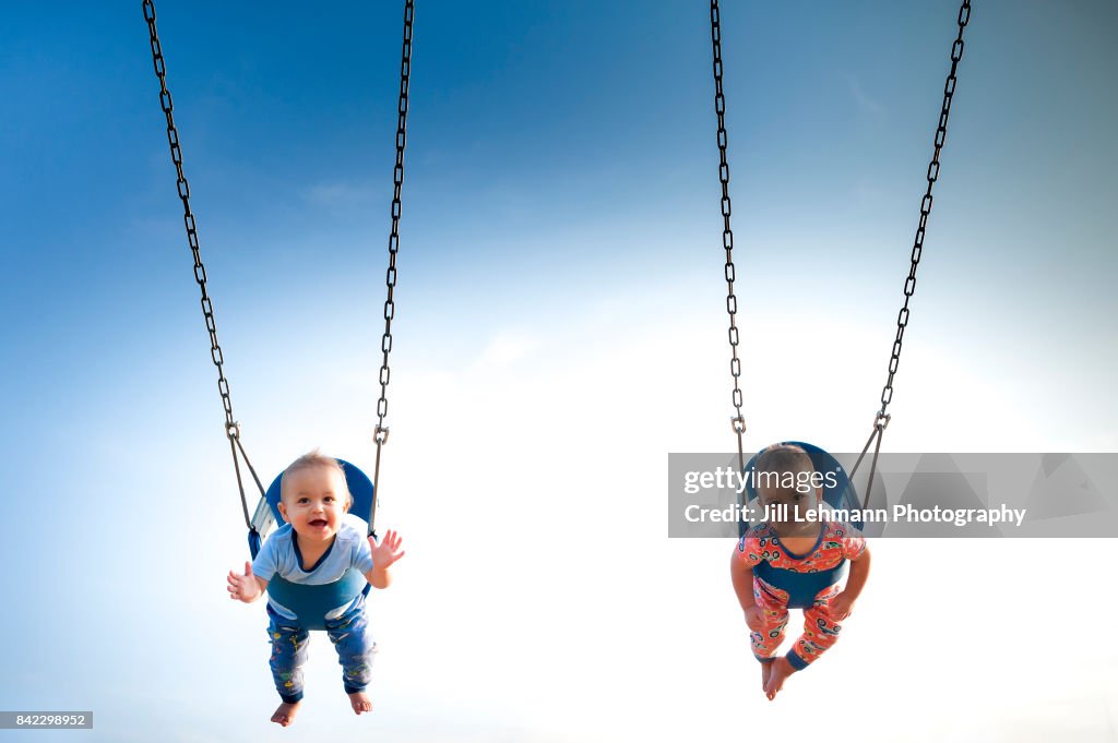 12 Month Old Fraternal Boys Swing in Pajamas at a Park