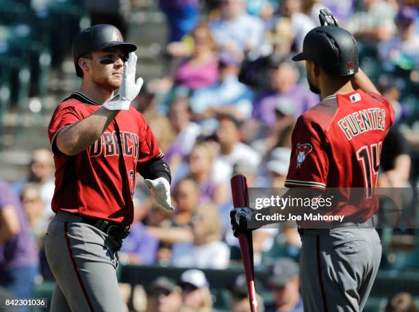 Brandon Drury of the Arizona Diamondbacks high fives Reymond Fuentes of the Arizona Diamondbacks after Drury's two-run home run in the sixth inning...