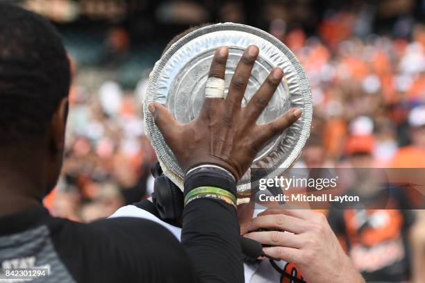 Adam Jones of the Baltimore Orioles puts a pie in the face of Mark Trumbo after after hitting game winning hit in the 12th inning during a baseball...