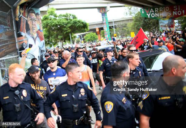 White Supremisist demonstrators are escorted to their cars by police officials during a solidarity rally at Chicano Park on September 3, 2017 in San...