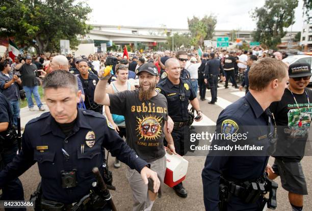 White Supremisist demonstrators are escorted to their cars by police officials during a solidarity rally at Chicano Park on September 3, 2017 in San...