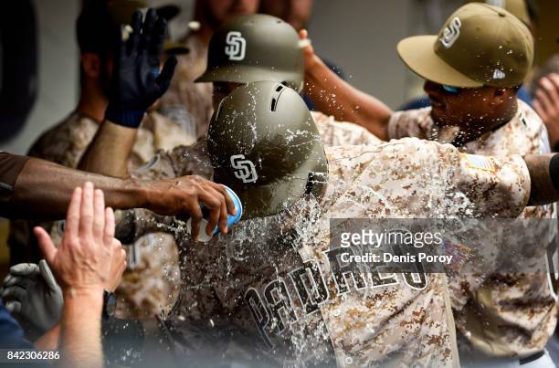 Erick Aybar of the San Diego Padres is congratulated after hitting a two-run home run during the fourth inning of a baseball game against the Los...