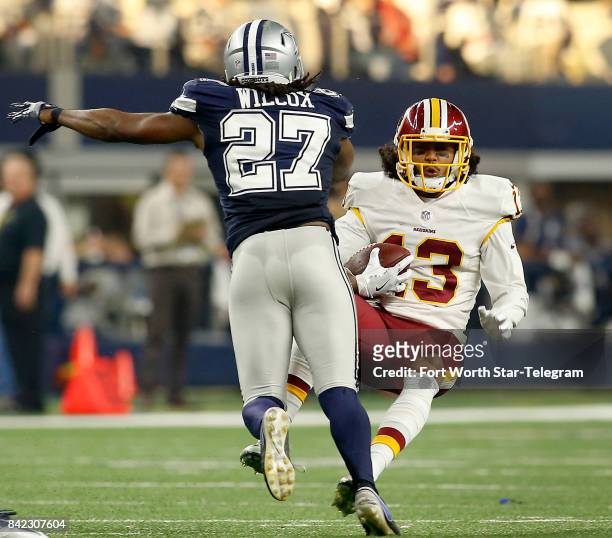 Washington Redskins wide receiver Maurice Harris is knocked down after a hit from Dallas Cowboys strong safety J.J. Wilcox in the first half on...