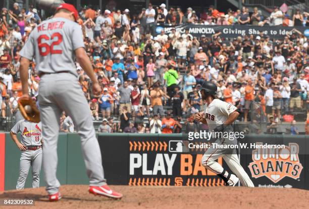 Madison Bumgarner of the San Francisco Giants trots around the bases after hitting a solo home run off of Luke Weaver of the St. Louis Cardinals in...