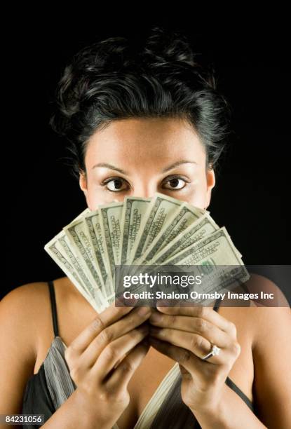 glamorous hispanic woman holding money - stereotypically upper class stock pictures, royalty-free photos & images