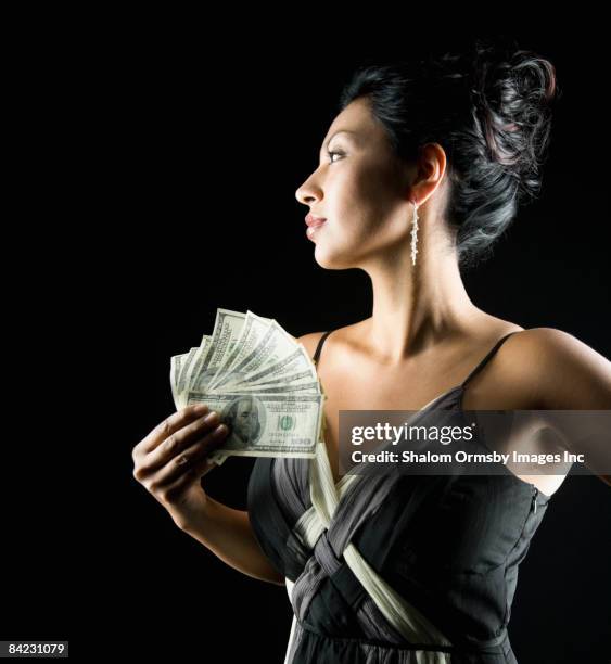 glamorous hispanic woman holding money - stereotypically upper class stock pictures, royalty-free photos & images