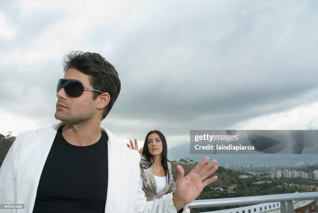 Hispanic couple arguing outdoors