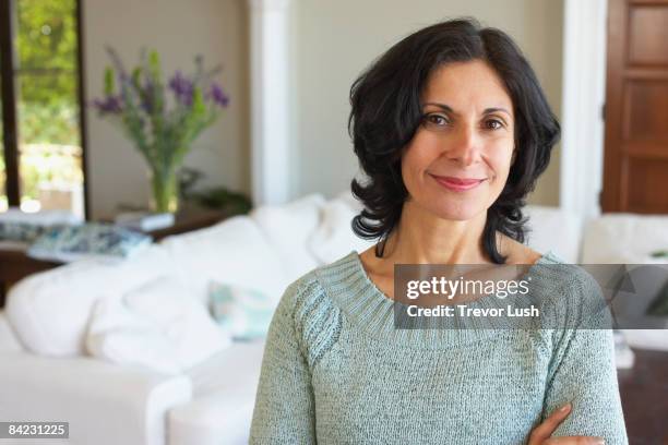 confident middle eastern woman in living room - arab home stock pictures, royalty-free photos & images