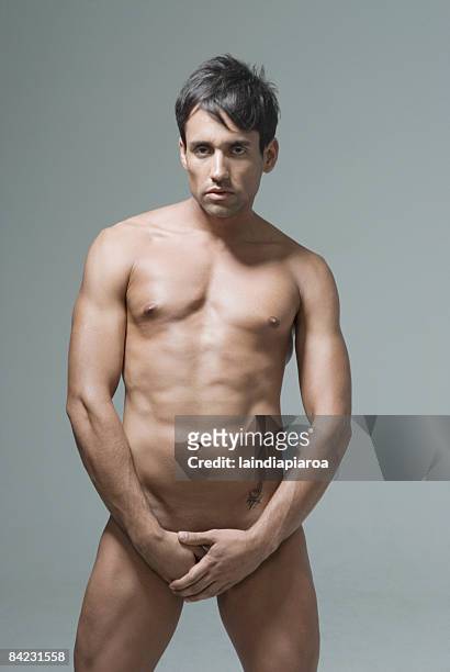 nude hispanic man covering his groin - male crotch stock pictures, royalty-free photos & images