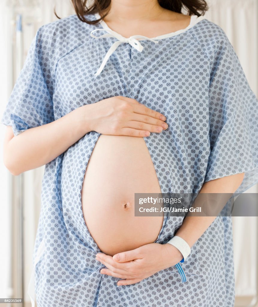 Pregnant Asian woman having checkup in doctor's office