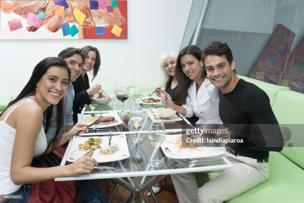 Hispanic friends eating in restaurant
