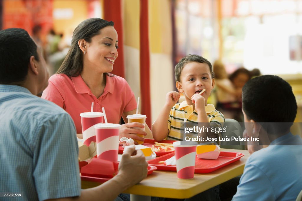 Hispanic family eating in fast food restaurant