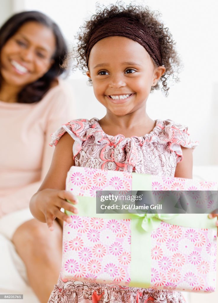 Granddaughter giving African grandmother gift