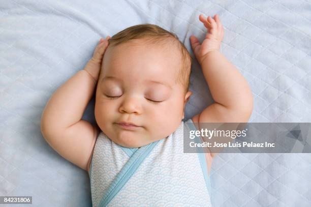 mixed race baby sleeping - baby sleeping stockfoto's en -beelden