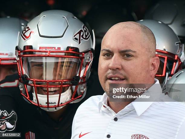 Quarterback Armani Rogers and head coach Tony Sanchez of the UNLV Rebels prepare to take the field before their game against the Howard Bison at Sam...