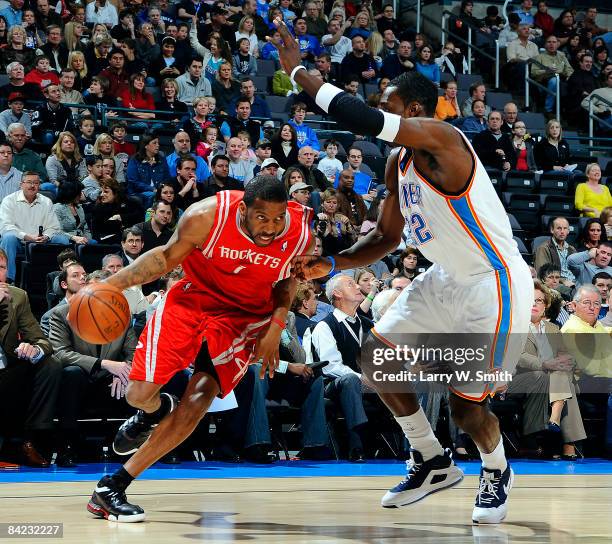 Tracy McGrady of the Houston Rockets goes to the basket against Jeff Green of the Oklahoma City Thunder at the Ford Center on January 9, 2009 in...
