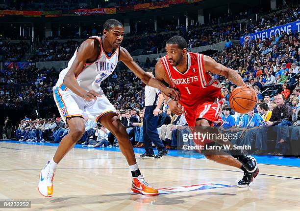 Tracy McGrady of the Houston Rockets goes to the basket against Kevin Durant of the Oklahoma City Thunder at the Ford Center on January 9, 2009 in...