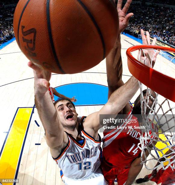 Nenad Krstic of the Oklahoma City Thunder goes to the basket against Carl Landry of the Houston Rockets at the Ford Center on January 9, 2009 in...