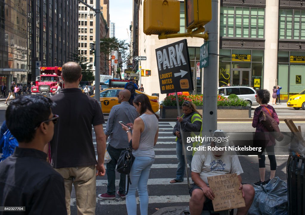 Pedestrians And Homeless In New York City