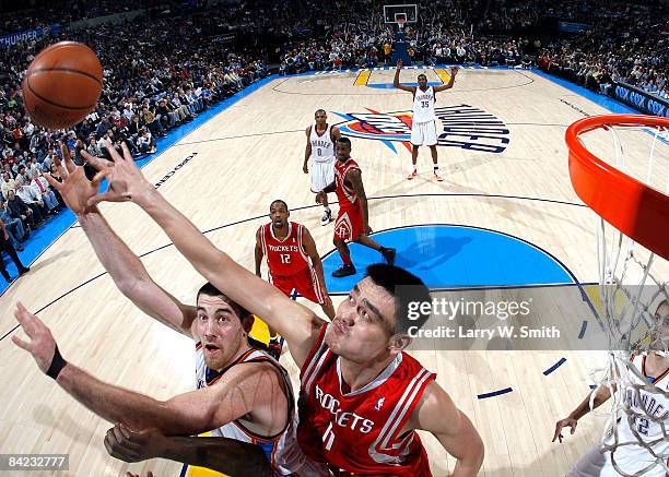 Nick Collison of the Oklahoma City Thunder goes to the basket against Yao Ming of the Houston Rockets at the Ford Center on January 9, 2009 in...