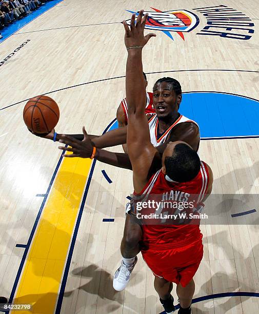 Kyle Weaver of the Oklahoma City Thunder goes to the basket against Chuck Hayes of the Houston Rockets at the Ford Center on January 9, 2009 in...