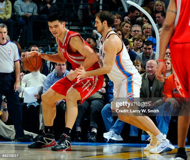 Yao Ming of the Houston Rockets goes to the basket against Nenad Krstic of the Oklahoma City Thunder at the Ford Center on January 9, 2009 in...