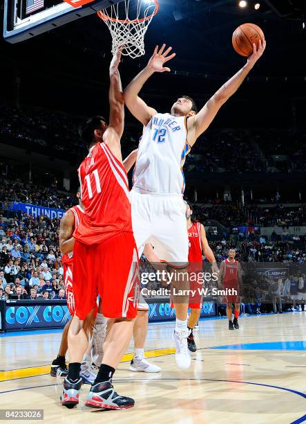 Nenad Krstic of the Oklahoma City Thunder goes to the basket against Yao Ming of the Houston Rockets at the Ford Center on January 9, 2009 in...