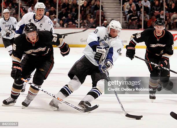 Vaclav Prospal of the Tampa Bay Lighting drives the puck through Samuel Pahlsson and Brett Festerling of the Anaheim Ducks during the game on January...