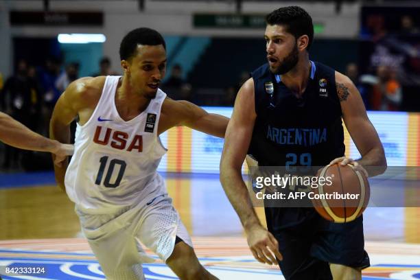 Argentina's small forward Patricio Garino drives the ball marked by USA's shooting guard Reggie Hearn during their 2017 FIBA Americas Championship...