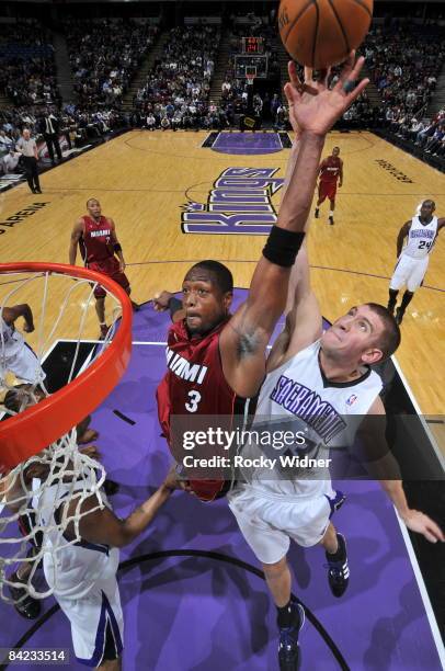 Dwyane Wade of the Miami Heat goes up for a dunk against Spencer Hawes of the Sacramento Kings on January 9, 2009 at ARCO Arena in Sacramento,...