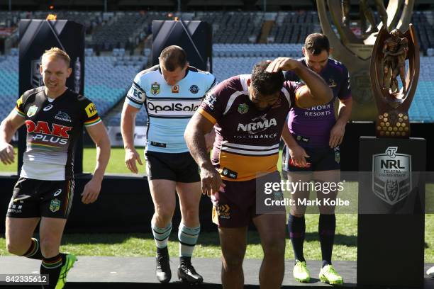 Peter Wallace of the Panthers, Paul Gallen of the Sharks, Sam Thaiday of the Broncos and Cameron Smith of the Storm react to the flame throwers used...