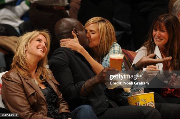 Musician Seal kisses his wife Heidi Klum on the Kiss Cam during a break in the action of a game between the Indiana Pacers and the Los Angeles Lakers...