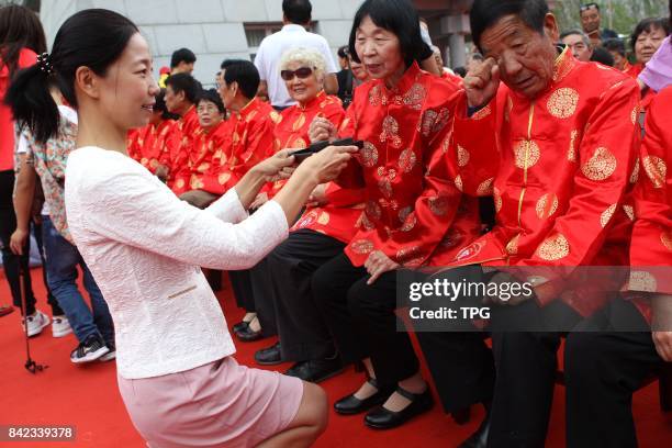 Golden wedding anniversary" ceremony is held for 86 elderly couples to celebrate their 50 years of marriage on the eve of the Qixi Festival, Chinese...
