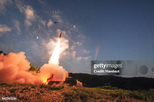 In this handout photo released by the South Korean Defense Ministry, South Korea's Hyunmu-2 ballistic missile is fired during an exercise aimed to...