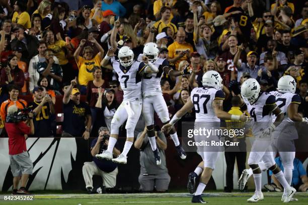 Quarterback Will Grier of the West Virginia Mountaineers celebrates after throwing a second half touchdown against the Virginia Tech Hokies at...