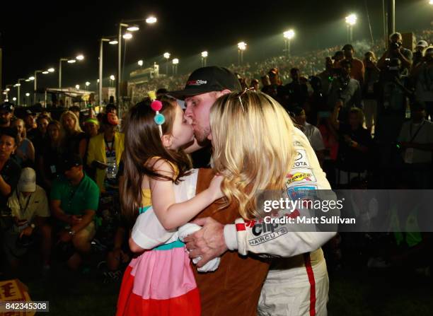 Denny Hamlin, driver of the Sport Clips Toyota, is greeted by his girlfriend Jordan Fish, and their daughter, Taylor, in Victory Lane after winning...