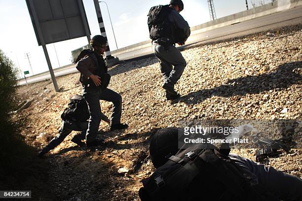 Group of emergency responders take cover after a siren sounded for an incoming rocket January 10, 2009 along the Israel-Gaza border in Israel....