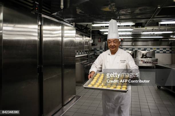 In this photo taken on August 21 chef Yip Wing-wah prepares to oven-bake his signature "spring moon mini egg custard mooncakes" at Hong Kong's famous...