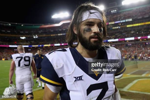 Quarterback Will Grier of the West Virginia Mountaineers walks off the field following their 31-24 loss to the Virginia Tech Hokies at FedExField on...
