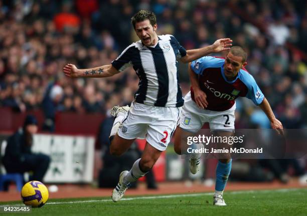 Luke Young of Aston Villa battles with Carl Hoefkens of West Bromwich Albion during the Barclays Premier League match between Aston Villa and West...