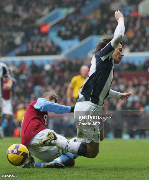 Ashley Young of Aston Villa tackles Robert Koren of West Bromwich Albion in the penalty area during the Premier League soccer match played between...