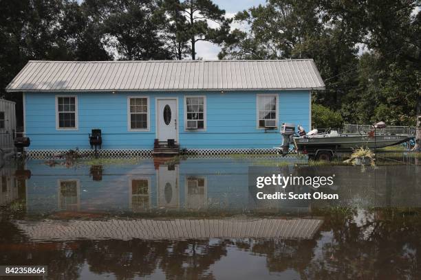 Floodwater surrounds a home after torrential rains pounded Southeast Texas following Hurricane and Tropical Storm Harvey causing widespread flooding...