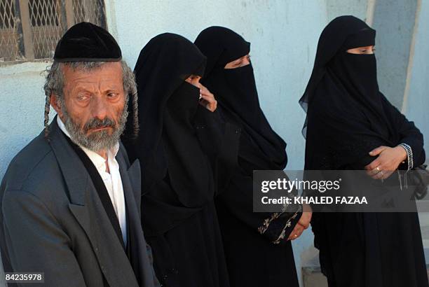 Yussuf , the father of a Yemeni Jew killed earlier this month in Raydah, 70 kms north of the capital Sanaa, stands with his daughters outside a court...