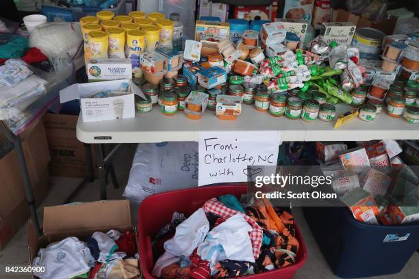 Table is filled with relief supplies that a group of friends brought from North Carolina to aid flood victims after torrential rains pounded...